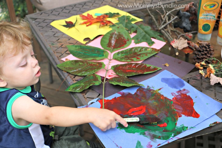 toddler painting leaves 