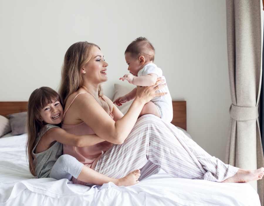 mom of two snuggling mom of two kids